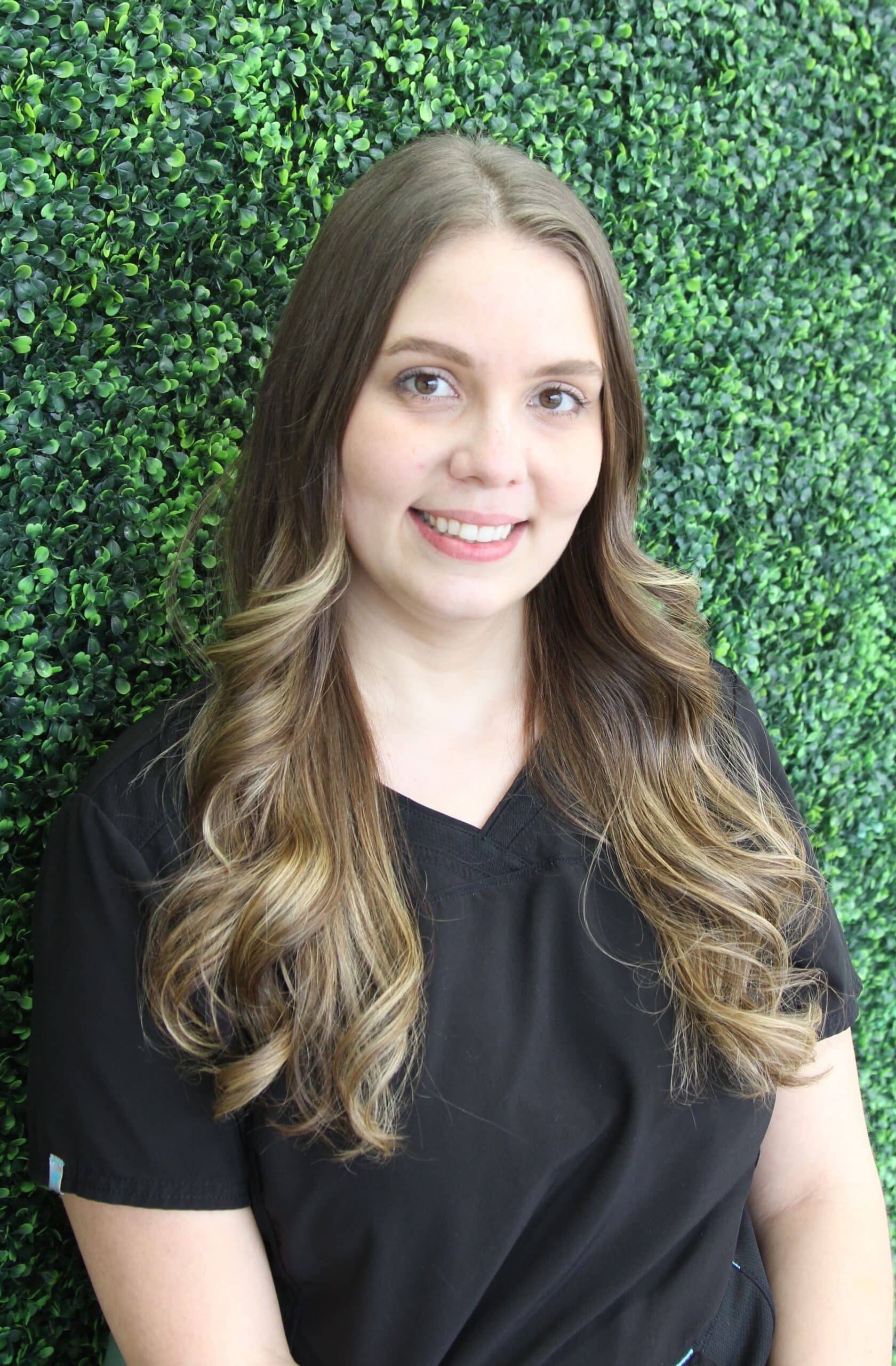 Friendly and happy female dental assistant at Spring Green Family Dental in Katy, TX