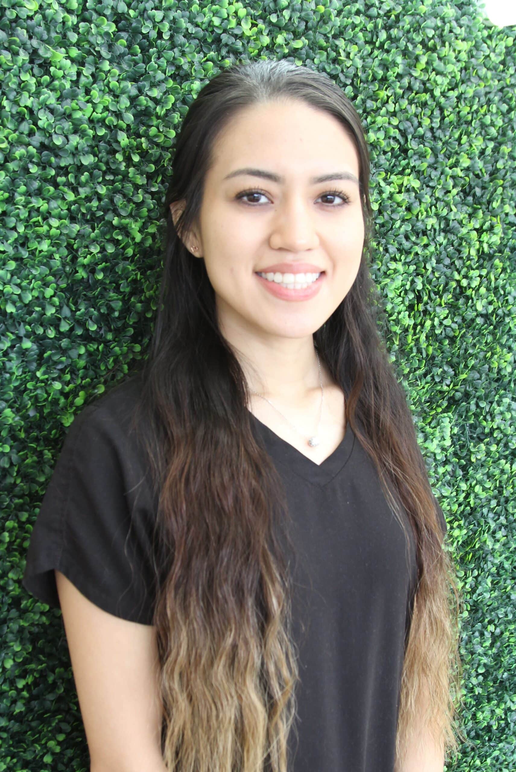 Friendly and happy female dental assistant at Spring Green Family Dental in Katy, TX