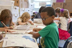 kid in class before visiting Katy family dentist
